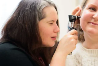 doctor providing ear exam