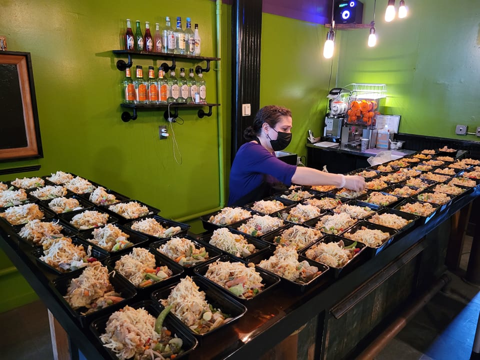 Attached Photo: Tacocat Cantina co-owner, Jenn Bird, packaging meals for the Upper Valley Everyone Eats program (photo courtesy of Tacocat Cantina).