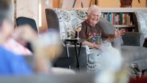 Betty Edson, enjoy a glass of wine at Gifford Health Care's Strode Independent Living Facility. Betty was Strode's first resident.